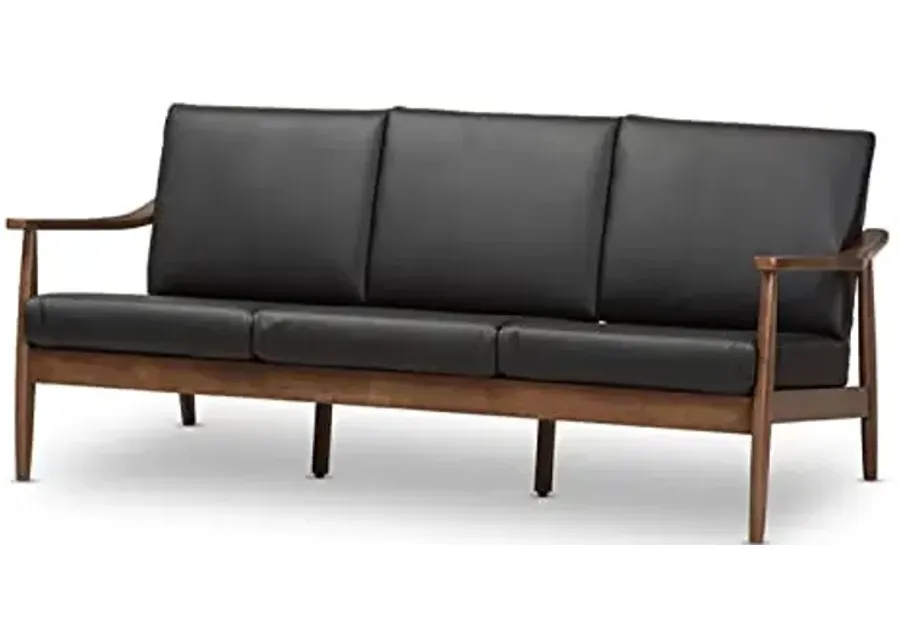 Baxton Studio Venza Mid-Century Modern Walnut Wood Black Faux Leather 3-Seater Sofa-Brown 1 60710-baxton-studio-venza-mid-century-modern-walnut-wood-black-faux-leather-3-seater-sofa-brown-1.webp